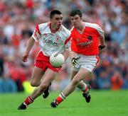 26 May 2002; Tyrone's Ryan McMenamin in action against Ronan Clarke of Armagh during the Bank of Ireland Ulster Senior Football Championship Quarter-Final Replay match between Armagh and Tyrone at St Tiernach's Park in Clones, Monaghan. Photo by Aoife Rice/Sportsfile
