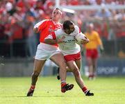 26 May 2002; Declan McCrossan of Tyrone in action against Paddy McKeever of Armagh during the Bank of Ireland Ulster Senior Football Championship Quarter-Final Replay match between Armagh and Tyrone at St Tiernach's Park in Clones, Monaghan. Photo by Aoife Rice/Sportsfile