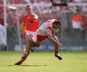 26 May 2002; Declan McCrossan of Tyrone in action against Paddy McKeever of Armagh during the Bank of Ireland Ulster Senior Football Championship Quarter-Final Replay match between Armagh and Tyrone at St Tiernach's Park in Clones, Monaghan. Photo by Aoife Rice/Sportsfile