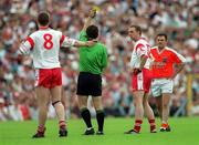 26 May 2002; Tyrone's Ger Cavlan, right, is shown the yellow card by referee Brian White during the Bank of Ireland Ulster Senior Football Championship Quarter-Final Replay match between Armagh and Tyrone at St Tiernach's Park in Clones, Monaghan. Photo by Aoife Rice/Sportsfile