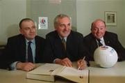 29 May 2002; An Taoiseach Bertie Ahern, T.D., centre, signs the Scotland - Ireland UEFA Euro 2008 Bid in the presence of the Bid Director John Henderson, left, and John Byrne, FAI Development Manager, at Government Buildings in Dublin. Soccer. Photo by Ray McManus/Sportsfile