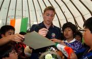 30 May 2002; Republic of Ireland's Matt Holland signs autographs during a farewell ceremony at Izumo Sports Park in Izumo, Japan, ahead of their first FIFA World Cup 2002 Group E match against Cameroon. Photo by David Maher/Sportsfile