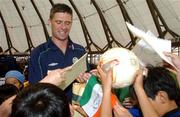 30 May 2002; Republic of Ireland's Niall Quinn signs autographs during a farewell ceremony at Izumo Sports Park in Izumo, Japan, ahead of their first FIFA World Cup 2002 Group E match against Cameroon. Photo by David Maher/Sportsfile