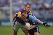1 June 2002; Ray Cosgrove of Dublin is tackled by Wexford's Niall Murphy during the Bank of Ireland Leinster Senior Football Championship Quarter-Final match between Wexford and Dublin at Dr. Cullen Park in Carlow. Photo by Matt Browne/Sportsfile