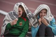 18 May 2017; Jenna Mortimor, left, and Leah Hunt, from Mt St Michael Secondary School, Mayo, stay dry between competing in the high jump during the Irish Life Health Connacht Schools Track and Field Championships at A.I.T, Athlone, in Co. Westmeath. Photo by Cody Glenn/Sportsfile