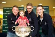 20 November 2011; Dublin players Paul Flynn, Eoghan O'Gara and Kevin Nolan when they signed a copy of the Dublin book  'A Rare Auld Season' for one year old Jenna Hynes, from Headford, Co. Galway, in Easons, O'Connell Street, Dublin. Picture credit: Ray McManus / SPORTSFILE