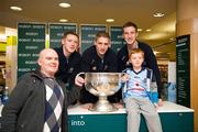 20 November 2011; Dublin players Paul Flynn, Eoghan O'Gara and Kevin Nolan when they signed a copy of the Dublin book  'A Rare Auld Season' for Barry, left, and seven year old Sean Ward, from Crumlin, in Easons, O'Connell Street, Dublin. Picture credit: Ray McManus / SPORTSFILE