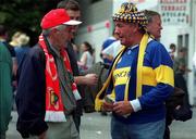2 July 2000; Two eldery men supporting opposing teams in conversation before the game. Cork v Tipperary, Guinness Munster Senior Hurling Final, Semple Stadium, Thurles, Co. Tipperary. Picture credit; Brendan Moran/SPORTSFILE
