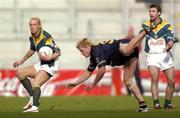 24 October 2004; Ireland's Ciaran McDonald, left and Graham Cullen in action against Adam McPhee, Australia. Coca Cola International Rules Series 2004, Second Test, Ireland v Australia, Croke Park, Dublin. Picture credit; Damien Eagers / SPORTSFILE *** Local Caption *** Any photograph taken by SPORTSFILE during, or in connection with, the 2004 Coca Cola International Rules Series which displays GAA logos or contains an image or part of an image of any GAA intellectual property, or, which contains images of a GAA player/players in their playing uniforms, may only be used for editorial and non-advertising purposes.  Use of photographs for advertising, as posters or for purchase separately is strictly prohibited unless prior written approval has been obtained from the Gaelic Athletic Association.