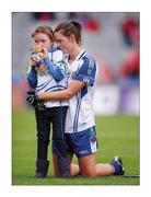 25 September 2011; The disappointment is best shared three ways. Monaghan’s Amanda Casey, her daughter Emma aged 7 and her toy mascot take in the final defeat to Cork. Picture credit; Pat Murphy / SPORTSFILE