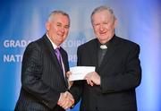 25 November 2011; Fr. Seamus Gardiner is presented with a gift from  by Uachtarán CLG Criostóir Ó Cuana on behalf of the GAA. 2011 National Referees' Awards Banquet, Croke Park, Dublin. Picture credit: Barry Cregg / SPORTSFILE