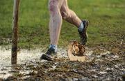 27 November 2011; An athlete makes their way through the mud during the senior men's race at the Woodie’s DIY Inter County Cross Country Championships. Sligo Racecourse, Sligo. Picture credit: Pat Murphy / SPORTSFILE