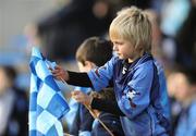 27 November 2011; A young Na Piarsaigh supporter tries to fix his damaged flag. AIB Munster GAA Hurling Senior Club Championship Final, Na Piarsaigh, Limerick v Crusheen, Clare, Semple Stadium, Thurles, Co. Tipperary. Picture credit: Diarmuid Greene / SPORTSFILE