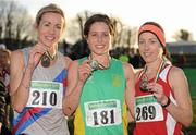 27 November 2011; Sara Louise Treacy, Meath, winner of the senior women's race at the Woodie’s DIY Inter County Cross Country Championships, with second placed, Claire McCarthy, Cork, right, and third placed Catherine Devitt, Dundrum South Dublin AC, left. Sligo Racecourse, Sligo. Picture credit: Pat Murphy / SPORTSFILE