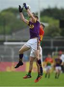 21 May 2017; Peadar Cowman of Wexford in action against John Byrne of Carlow during the Electric Ireland Leinster GAA Football Minor Championship Quarter Final match between Carlow and Wexford at Netwatch Cullen Park in Carlow. Photo by Ramsey Cardy/Sportsfile