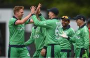 21 May 2017; Barry McCarthy, second from left, celebrates with team-mate Craig Young of Ireland after catching Tom Latham, but Young, the bowler, was subsequently ruled for a No Ball penalty during the One Day International match between Ireland and New Zealand at Malahide Cricket Club in Dublin. Photo by Cody Glenn/Sportsfile