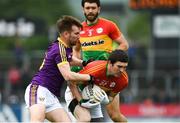 21 May 2017; Conor Lawlor of Carlow is tackled by PJ Banville of Wexford during the Leinster GAA Football Senior Championship Round 1 match between Carlow and Wexford at Netwatch Cullen Park in Carlow. Photo by Ramsey Cardy/Sportsfile