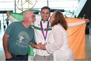 22 May 2017; Cian McManamon, centre, of the Ireland Men's Race Walking Team, who won bronze in the 20km at The European Race Walking Cup in Podebrady, Czech Republic, pictured on his return with parents Noel and Marian McManamon, at Dublin Airport in Dublin. Photo by Seb Daly/Sportsfile