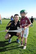 3 December 2011; Galway's David Collins with Keelin Walsh, from the San Francisco GAA Club, during a coaching session organised as part of the tour. Keelin's dad Vivian is from Ballinasloe, Co. Galway. 2011 GAA GPA All-Stars Hurling Tour sponsored by Opel, Treasure Island, San Francisco, California, USA. Picture credit: Ray McManus / SPORTSFILE