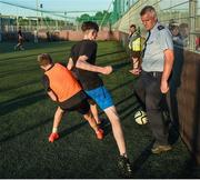 26 May 2017; Community Garda Pat Courtney, of Tallaght Garda Station, gets close to the action during the FAI South Dublin County Council Late Night League Finals at Astropark in Tallaght, Dublin. Photo by Seb Daly/Sportsfile