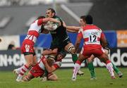 10 December 2011; Geore Naoupu, Connacht, is tackled by, from left, Freddie Burns, Andy Hazell and Eliota Fuimaono-Sapolu, Gloucester. Heineken Cup, Pool 6, Round 3, Connacht v Gloucester, Sportsground, Galway. Picture credit: Pat Murphy / SPORTSFILE