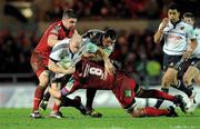 10 December 2011; Paul O'Connell, supported by James Coughlan, Munster, is tackled by Ben Morgan and Rob McCusker, left, Scarlets. Heineken Cup, Pool 1, Round 3, Scarlets v Munster, Parc Y Scarlets, Llanelli, Wales. Picture credit: Diarmuid Greene / SPORTSFILE