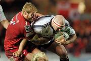 10 December 2011; John Hayes, Munster, is tackled by Damian Welch, Scarlets. Heineken Cup, Pool 1, Round 3, Scarlets v Munster, Parc Y Scarlets, Llanelli, Wales. Picture credit: Diarmuid Greene / SPORTSFILE