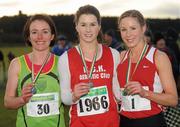 11 December 2011; Laura Behan, K.C.K. AC, winner, with second placed Catherine Devitt, Rathfarnham W.S.A.F. AC, left, and third placed Martina Kelly. St. Finbarrs AC, right, after the Women's Novice race at the Woodie’s DIY Novice and Juvenile Cross Country Championships. Curragh Camp, The Curragh, Co. Kildare. Picture credit: Pat Murphy / SPORTSFILE