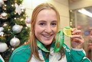 12 December 2011; Fionnuala Britton with her gold medal on her arrival at Dublin airport following the 18th SPAR European Cross Country Championships 2011 in Slovenia. Dublin Airport, Dublin. Photo by Sportsfile