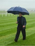 27 May 2017; Jockey Ryan Moore walks the course in heavy rain ahead of the races at Tattersalls Irish Guineas Festival at The Curragh, Co Kildare. Photo by Cody Glenn/Sportsfile