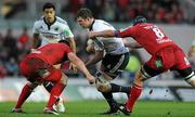 10 December 2011; Donnacha Ryan, Munster, is tackled by Rob McCusker, left, and Ben Morgan, Scarlets. Heineken Cup, Pool 1, Round 3, Scarlets v Munster, Parc Y Scarlets, Llanelli, Wales. Picture credit: Diarmuid Greene / SPORTSFILE