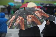 27 May 2017; Racegoers huddle under umbrellas during the Tattersalls Irish Guineas Festival at The Curragh, Co Kildare. Photo by Cody Glenn/Sportsfile