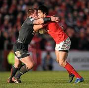 18 December 2011; Conor Murray, Munster, is tackled by Matthew Rees, Scarlets. Heineken Cup, Pool 1, Round 4, Munster v Scarlets, Thomond Park, Limerick. Picture credit: Stephen McCarthy / SPORTSFILE