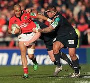 18 December 2011; Simon Zebo, Munster, tackled by Matthew Rees, left, and Rhys Thomas, Scarlets. Heineken Cup, Pool 1, Round 4, Munster v Scarlets, Thomond Park, Limerick. Picture credit: Stephen McCarthy / SPORTSFILE