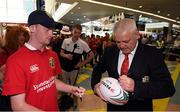 31 May 2017; British and Irish Lions head coach Warren Gatland signs an autograph as the British and Irish Lions squad arrive at Auckland Airport in New Zealand. Photo by Stephen McCarthy/Sportsfile