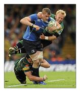21 May 2011; Jamie Heaslip, Leinster, is tackled by Phil Dowson and Shane Geraghty, right, Northampton Saints. Heineken Cup Final, Leinster v Northampton Saints, Millennium Stadium, Cardiff, Wales. Picture credit: Matt Browne / SPORTSFILE