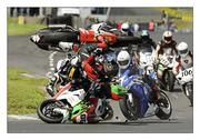 8 May 2011; Dylan Fox, 71, 1000cc Suzuki, flies into the air after colliding with Mark Pollock, 86, 1000cc Suzuki, centre, and also Brian McCormick, left, at the first corner of the second Superbike race. Adelaide Masters Series, Mondello Park International Racing Circuit, Donore, Naas, Co. Kildare. Picture credit: Barry Cregg / SPORTSFILE