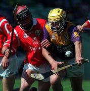 9 August 1998; Anthony Walsh of Wexford is tackled by Eoin O'Sullivan of Cork during the All-Ireland Minor Hurling Championship Semi-Final match between Cork and Wexford at Croke Park in Dublin. Photo by Brendan Moran/Sportsfile