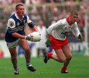 27 September 1998; Brian Fitzpatrick of Laois gets past Kevin Hughes of Tyrone during the All-Ireland Minor Football Championship Final between Laois and Tyrone at Croke Park in Dublin. Photo by Ray McManus/Sportsfile