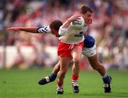 28 September 1998; Brian McGuigan ofTyrone is tackled by Kevin Hughes of Laois during the All-Ireland Minor Football Championship Final between Laois and Tyrone at Croke Park in Dublin. Photo by Ray McManus/Sportsfile