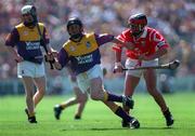 9 August 1998; James McDonald of Wexford is tackled by Victor Cusack of Cork during the All-Ireland Minor Hurling Championship Semi-Final match between Cork and Wexford at Croke Park in Dublin. Photo by Ray McManus/Sportsfile