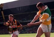 13 September 1998; Kevin Martin of Offaly clears downfield despite the blockdown attempt by Kilkenny's Charlie Carter of Kilkenny during the Guinness All-Ireland Senior Hurling Championship Final match between Kilkenny and Offaly at Croke Park in Dublin. Photo by Ray McManus/Sportsfile