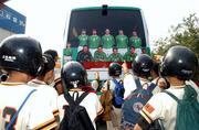 2 June 2002; A local junior baseball team view the Republic of Ireland team coach, showing a picture displaying only ten players, with Roy Keane taken out, during a Republic of Ireland training session in Chiba, Japan. Photo by David Maher/Sportsfile