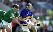 2 June 2002; Eoin Kelly of Tipperary is tackled by TJ Ryan of Limerick during the Guinness Munster Senior Hurling Championship Semi-Final match between Tipperary and Limerick at Páirc Uí Chaoimh in Cork. Photo by Brendan Moran/Sportsfile