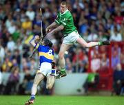 2 June 2002; Ciaran Carey of Limerick in action against Tipperary's Thomas Dunne during the Guinness Munster Senior Hurling Championship Semi-Final match between Tipperary and Limerick at Páirc Uí Chaoimh in Cork. Photo by Brendan Moran/Sportsfile