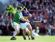 2 June 2002;  John Carroll of Tipperary is tackled by TJ Ryan of Limerick during the Guinness Munster Senior Hurling Championship Semi-Final match between Tipperary and Limerick at Páirc Uí Chaoimh in Cork. Photo by Brendan Moran/Sportsfile