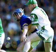 2 June 2002; Eugene O'Neill of Tipperary is tackled by Joe Quaid of Limerick during the Guinness Munster Senior Hurling Championship Semi-Final match between Tipperary and Limerick at Páirc U’ Chaoimh in Cork. Photo by Brendan Moran/Sportsfile