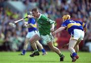 2 June 2002; Ciaran Carey of Limerick breaks clear of Eamonn Corcoran of Tipperary during the Guinness Munster Senior Hurling Championship Semi-Final match between Tipperary and Limerick at Páirc U’ Chaoimh in Cork. Photo by Brendan Moran/Sportsfile