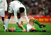 16 May 2002; Nigeria's Nwanko Kanu attempts to help Republic of Ireland's Roy Keane to his feet following a challenge on him during the International Friendly match between Republic of Ireland and Nigeria at Lansdowne Road in Dublin. Photo by David Maher/Sportsfile