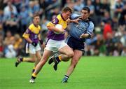 1 June 2002; Diarmuid Kinsella of Wexford in action against Jonathan Magee of Dublin during the Bank of Ireland Leinster Senior Football Championship Quarter-Final match between Wexford and Dublin at Dr. Cullen Park in Carlow. Photo by Damien Eagers/Sportsfile